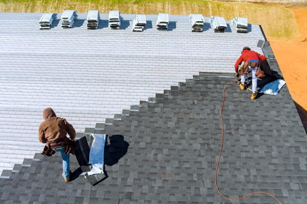 worker hands installing bitumen roof shingles with 2022 11 12 11 28 00 utc 1