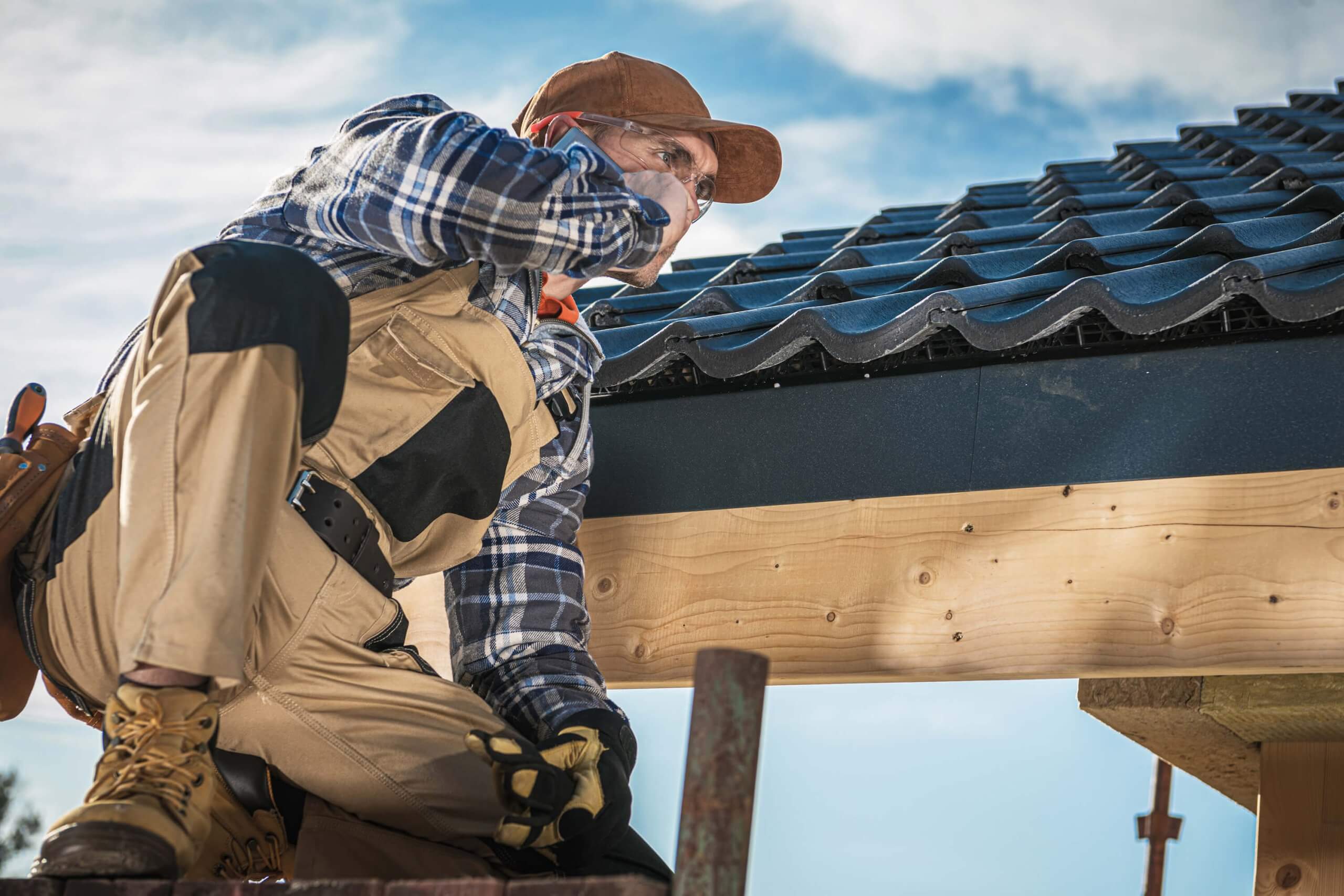 roof contractor talking on cell phone 2022 12 16 11 41 26 utc 1 scaled