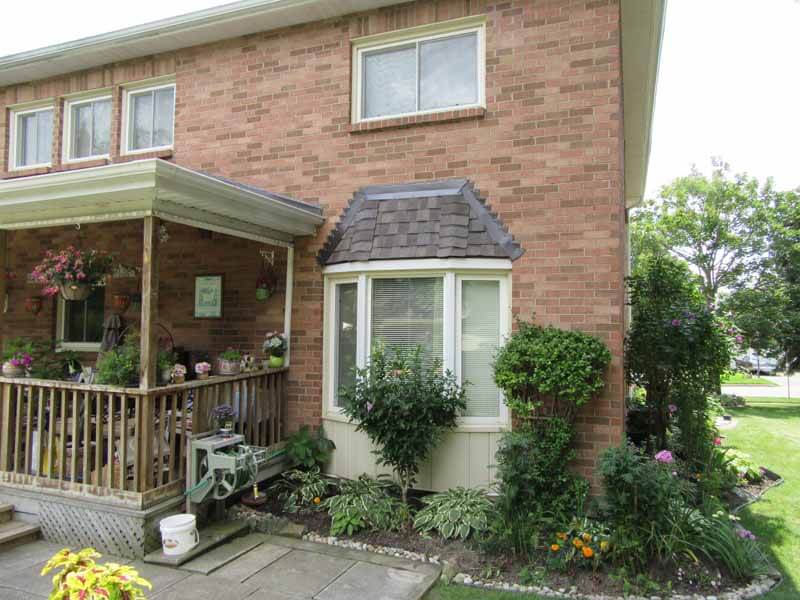 Bay window shingle repair on home