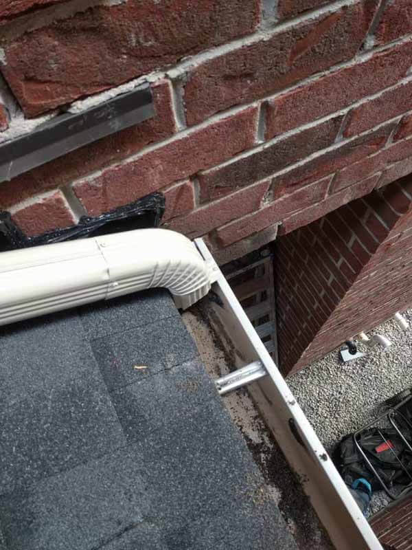 Eavestrough and gutter cleaning service on residential roof