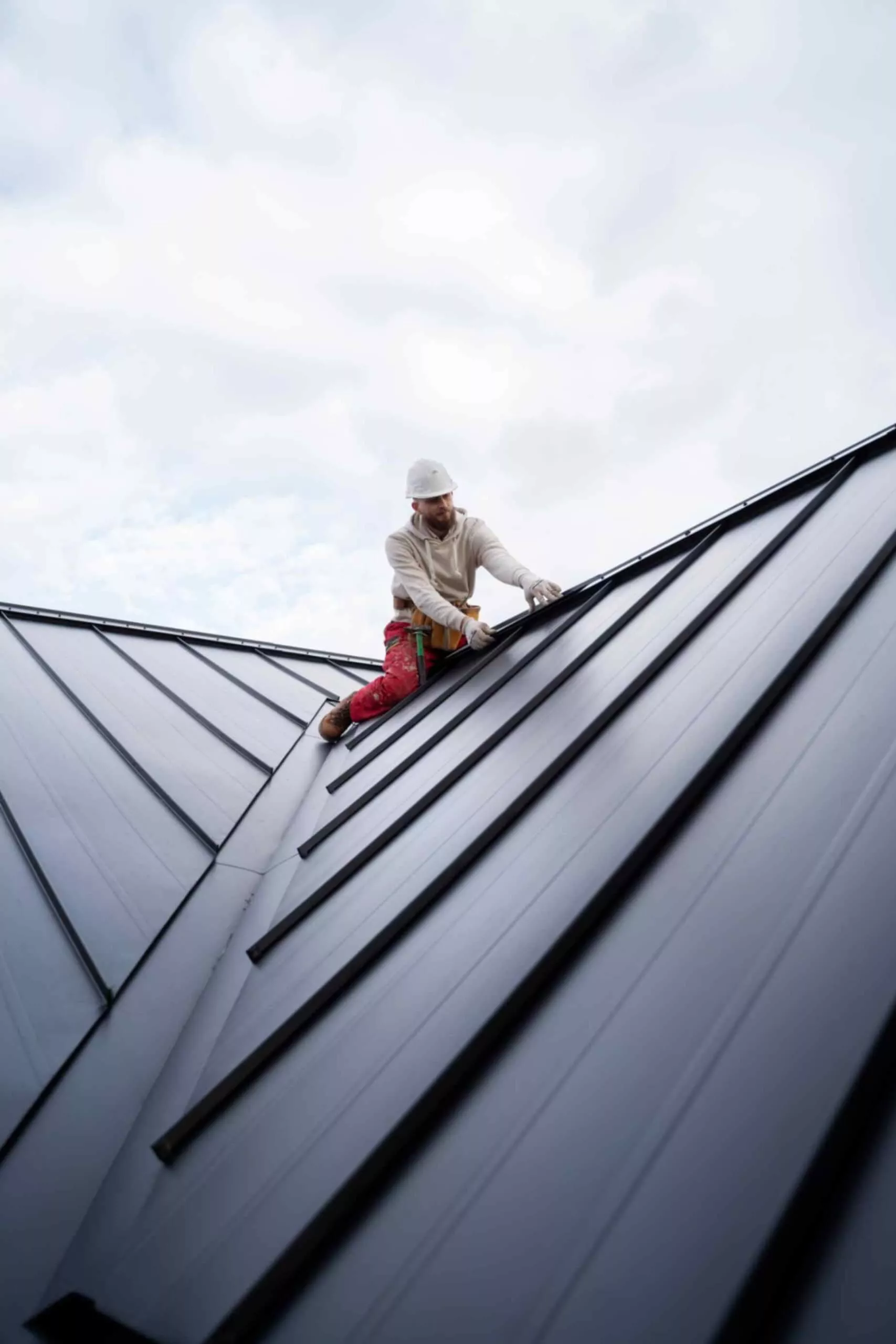 Roofing professional repairing a commercial building roof in Milton
