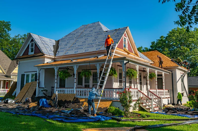 Clay roofing tiles stacked on a sloped roof during installation
