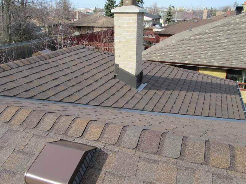 displays architectural shingles and a brick chimney mississauga