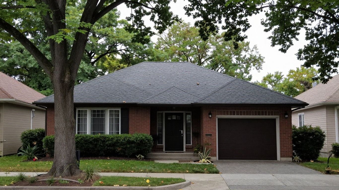 Weathered asphalt shingles showing granule loss and curling on an Oakville home roof